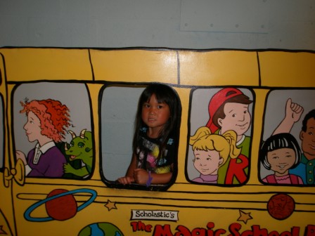 Kasen in a bus picture at Adventure Science Center